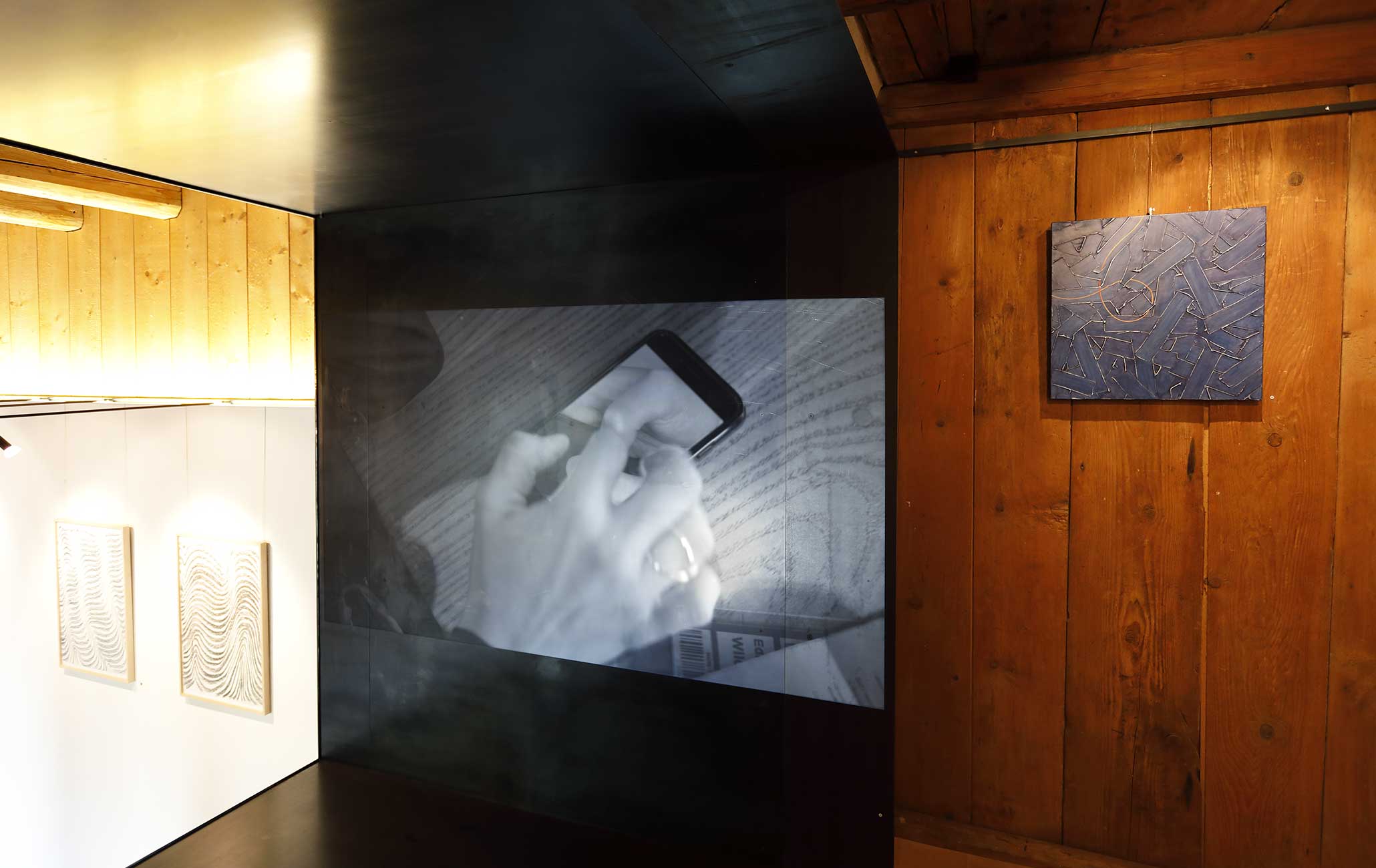 Exhibition 'Felix Thyes – Ad Infinitum', Kulturschüür Männedorf, CH, 2019. Center: Myriam Thyes, Smart Pantheon (2016), HD video. Left: Felix Thyes, drawings of 2017, charcoal (and pastels) on paper. Right: Vanessa Thyes, 'Blues' (2018), tempera on canvas.